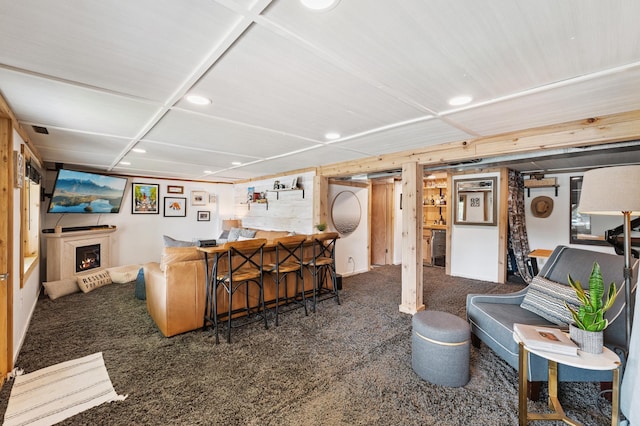 13491 80th St NW, Annandale, MN 55302 - living area with recessed lighting, wet bar, a lit fireplace, and carpet flooring
