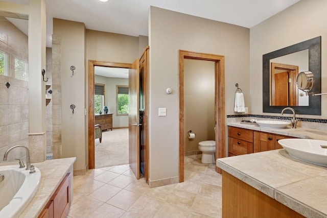 1656 Isabella Pkwy, Chaska, MN 55318 - bathroom with vanity, a garden tub, tile patterned flooring, and tiled shower