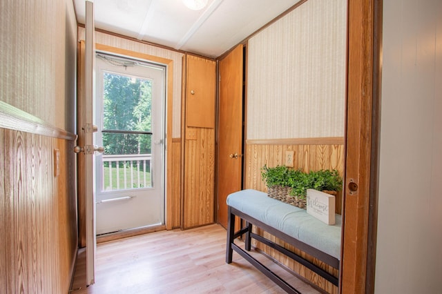N6050 270th St, Lucas Twp, WI 54751 - doorway to outside featuring light wood-style flooring, a wainscoted wall, wooden walls, and wallpapered walls