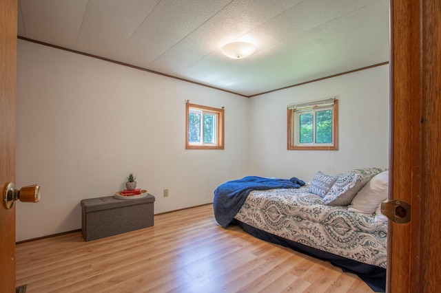 N6050 270th St, Lucas Twp, WI 54751 - bedroom with multiple windows, wood finished floors, and crown molding
