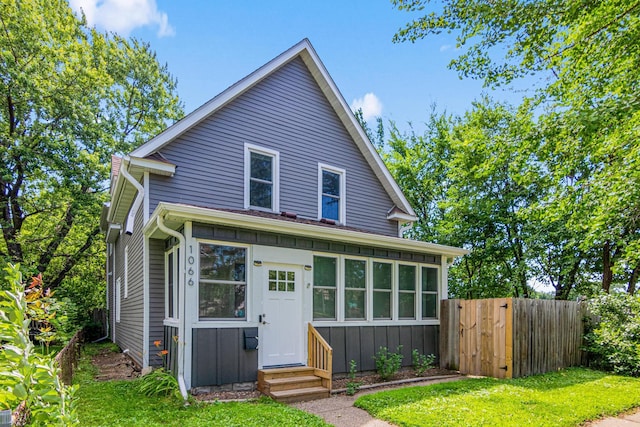1066 Woodbridge St, Saint Paul, MN 55117 - view of front of house with entry steps, board and batten siding, and a gate