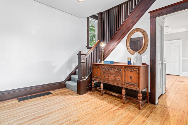 1066 Woodbridge St, Saint Paul, MN 55117 - stairs featuring hardwood / wood-style flooring and baseboards