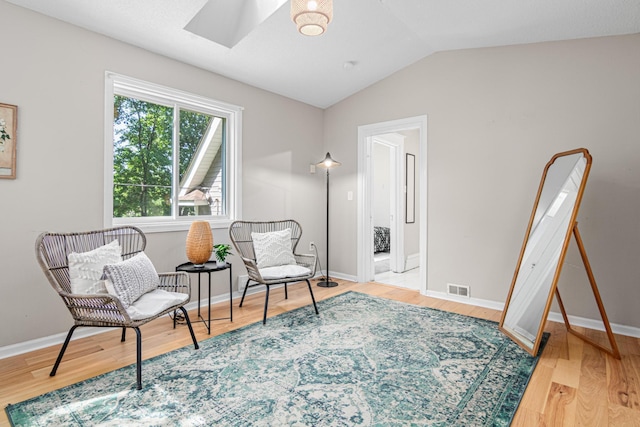 1066 Woodbridge St, Saint Paul, MN 55117 - living area with a skylight, vaulted ceiling, and wood finished floors
