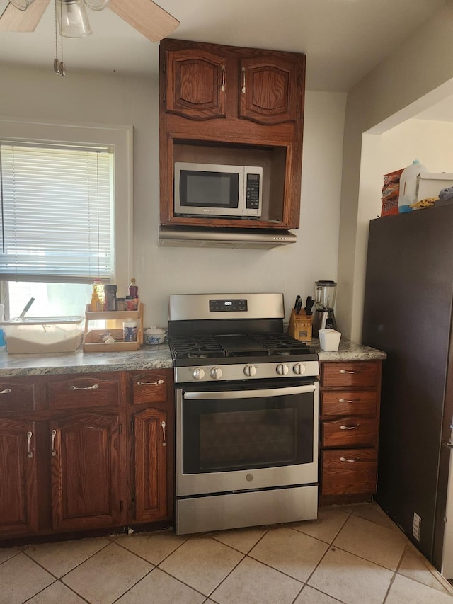2611 Longfellow Ave, Minneapolis, MN 55407 - kitchen with stainless steel appliances, light tile patterned floors, and a ceiling fan