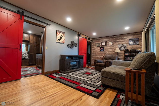 1606 5th St N, Fargo, ND 58102 - living room with a barn door, wood walls, light wood finished floors, an accent wall, and recessed lighting