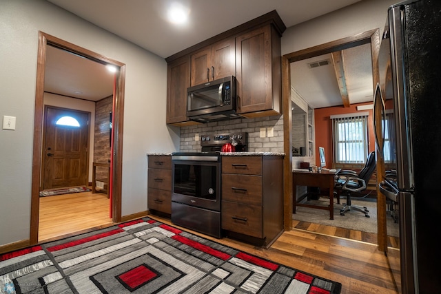 1606 5th St N, Fargo, ND 58102 - kitchen with appliances with stainless steel finishes, light wood-type flooring, an office area, dark brown cabinets, and backsplash