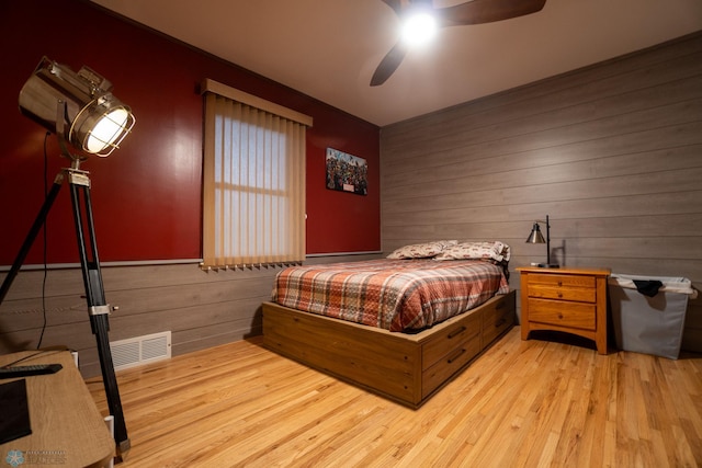 1606 5th St N, Fargo, ND 58102 - bedroom with wooden walls, light wood-type flooring, and ceiling fan