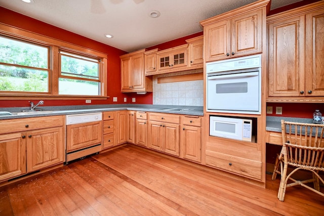 S3093 Baertsch Valley Rd, Cross Twp, WI 54629 - kitchen featuring white appliances, light wood-style floors, decorative backsplash, recessed lighting, and glass insert cabinets