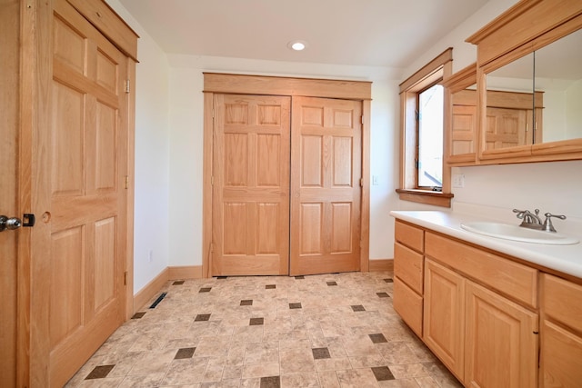 S3093 Baertsch Valley Rd, Cross Twp, WI 54629 - bathroom featuring vanity, recessed lighting, and stone finish flooring