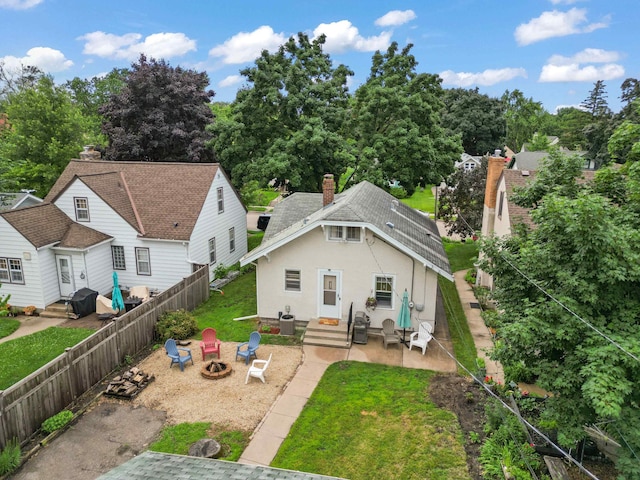 4334 Thomas Ave N, Minneapolis, MN 55412 - back of house with entry steps, an outdoor fire pit, stucco siding, a patio area, and a fenced backyard