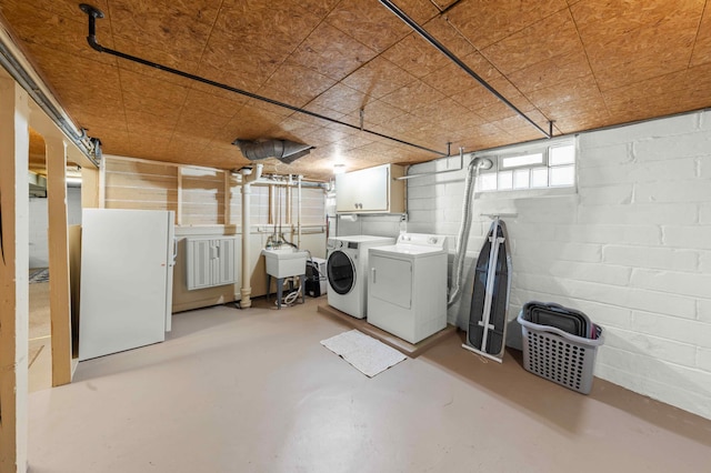 4334 Thomas Ave N, Minneapolis, MN 55412 - basement featuring washing machine and clothes dryer and freestanding refrigerator