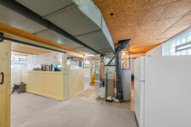 4334 Thomas Ave N, Minneapolis, MN 55412 - basement with freestanding refrigerator, carpet, plenty of natural light, and heating unit
