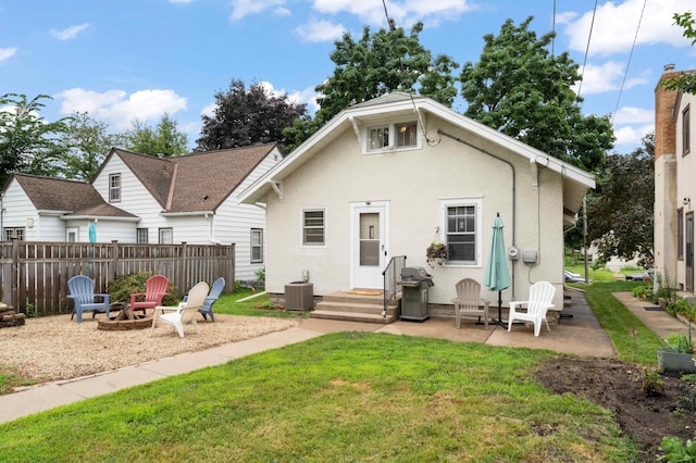 4334 Thomas Ave N, Minneapolis, MN 55412 - rear view of property featuring an outdoor fire pit, stucco siding, and a patio area