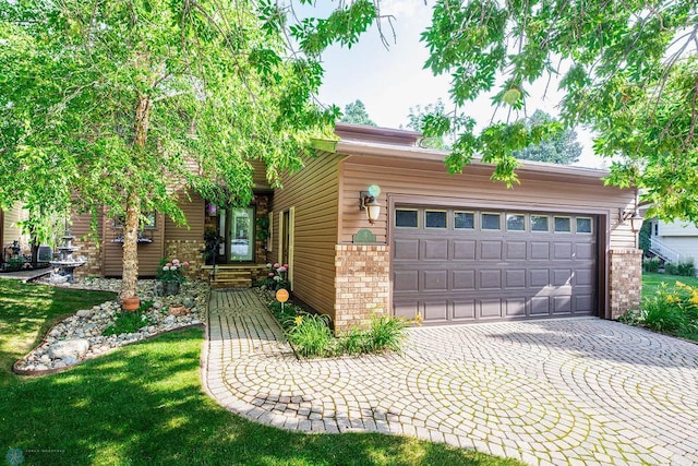 15 Fremont Dr S, Fargo, ND 58103 - view of front facade with brick siding, driveway, and a garage