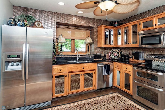 15 Fremont Dr S, Fargo, ND 58103 - kitchen with appliances with stainless steel finishes, a ceiling fan, glass insert cabinets, brown cabinetry, and recessed lighting