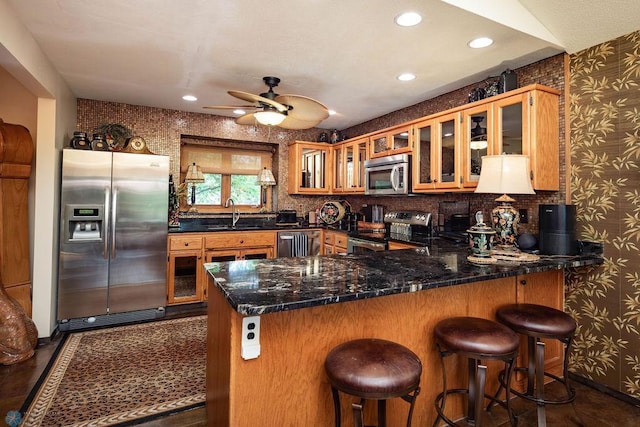 15 Fremont Dr S, Fargo, ND 58103 - kitchen featuring stainless steel appliances, wallpapered walls, a peninsula, a ceiling fan, and recessed lighting