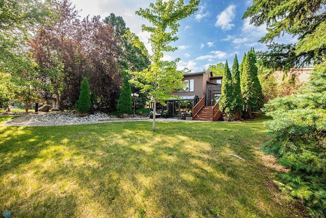 15 Fremont Dr S, Fargo, ND 58103 - view of green lawn featuring a wooden deck and stairs