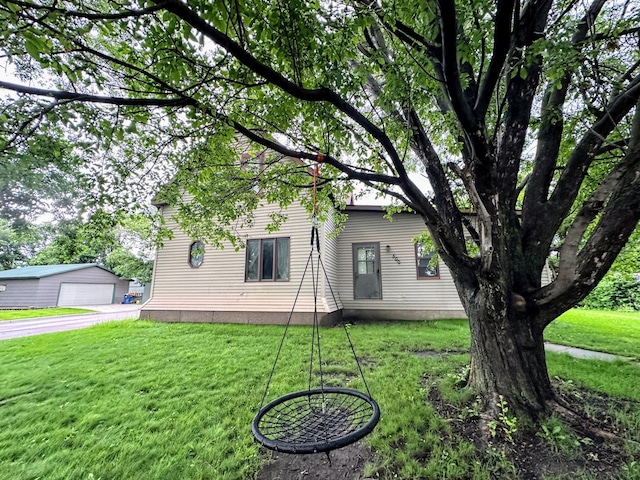 500 Main Ave, Lafayette, MN 56054 - back of property featuring a garage, a lawn, and an outdoor structure