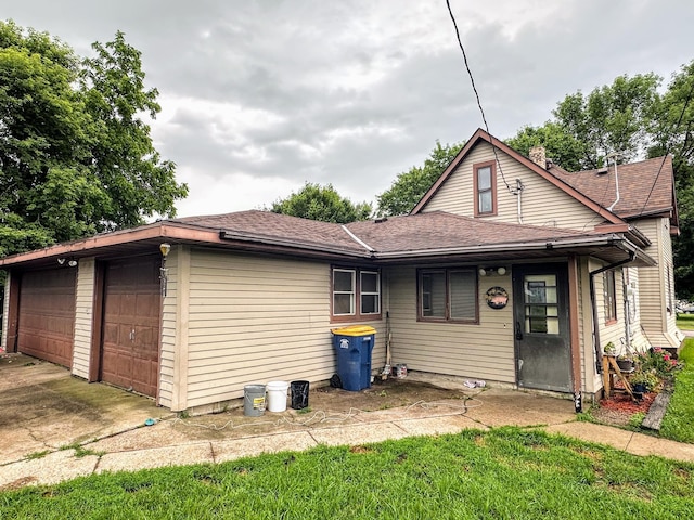 500 Main Ave, Lafayette, MN 56054 - rear view of property with a garage and a shingled roof