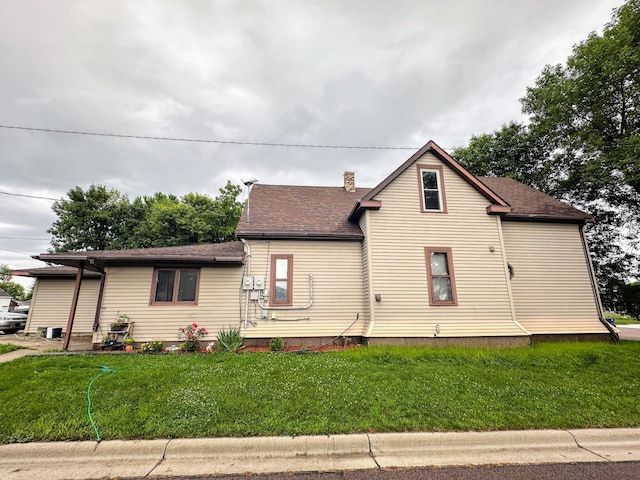 500 Main Ave, Lafayette, MN 56054 - view of front of house with a front lawn, a chimney, and roof with shingles