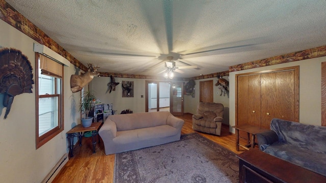 500 Main Ave, Lafayette, MN 56054 - living room with a textured ceiling, baseboard heating, light wood-type flooring, and a ceiling fan