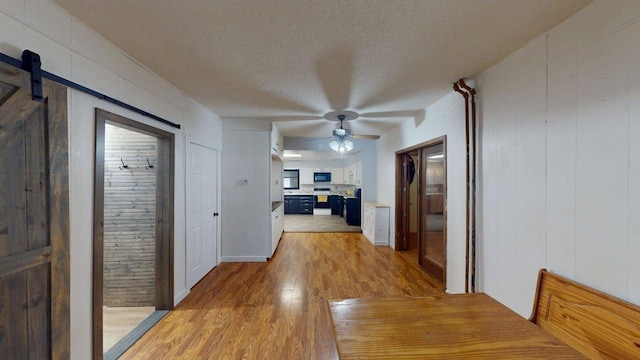 500 Main Ave, Lafayette, MN 56054 - hall with light wood finished floors, a textured ceiling, and a barn door