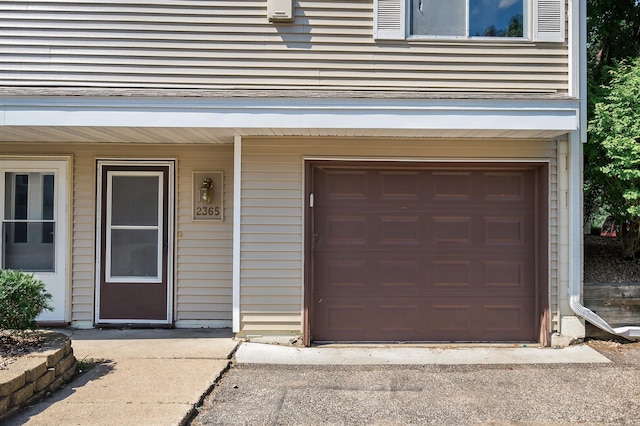 2365 Dorland Ln E, Maplewood, MN 55119 - doorway to property with an attached garage