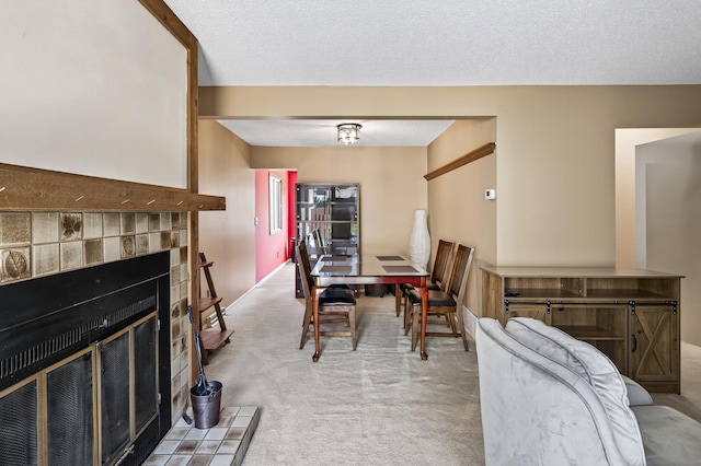 2365 Dorland Ln E, Maplewood, MN 55119 - carpeted dining area with a tile fireplace and a textured ceiling