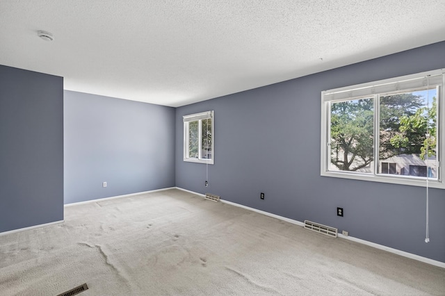2365 Dorland Ln E, Maplewood, MN 55119 - carpeted spare room featuring a smoke detector and a textured ceiling