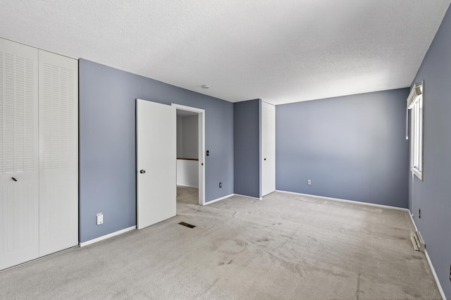 2365 Dorland Ln E, Maplewood, MN 55119 - unfurnished bedroom with carpet, a closet, and a textured ceiling
