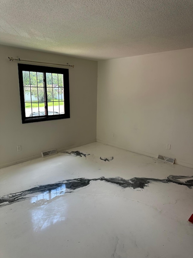 117 Quincy St, Alexandria, MN 56308 - unfurnished room with a textured ceiling
