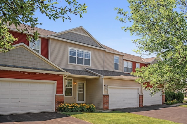 651 Ravencroft Rd, Waconia, MN 55387 - view of property with asphalt driveway, brick siding, and roof with shingles