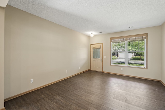 651 Ravencroft Rd, Waconia, MN 55387 - unfurnished room featuring a textured ceiling and dark wood-type flooring