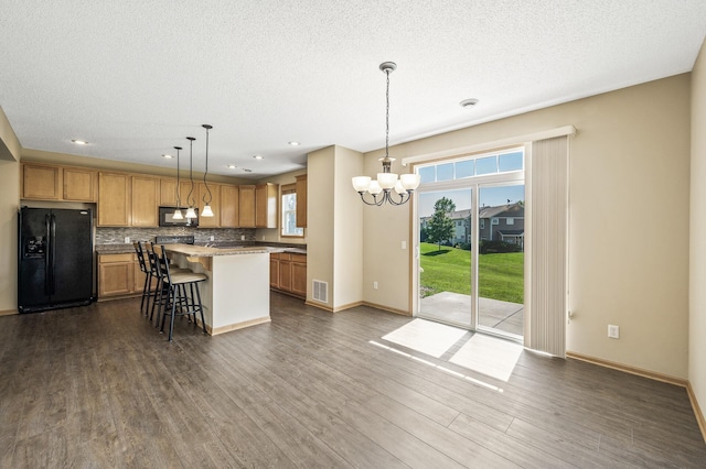 651 Ravencroft Rd, Waconia, MN 55387 - kitchen featuring black appliances, a kitchen breakfast bar, a chandelier, dark wood-type flooring, and tasteful backsplash