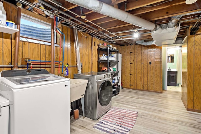 5501 30th Ave S, Minneapolis, MN 55417 - laundry room featuring washing machine and dryer, wooden walls, and wood finished floors