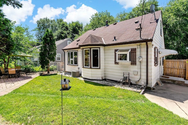 5501 30th Ave S, Minneapolis, MN 55417 - view of front facade featuring a patio area, a fenced backyard, and a shingled roof