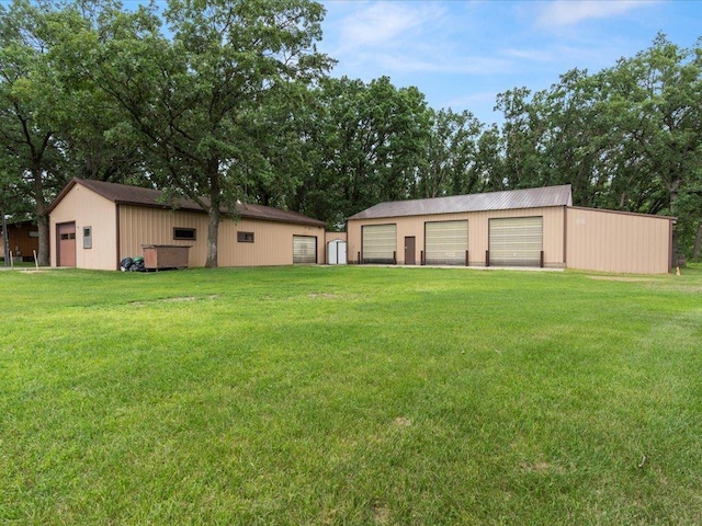 15170 141st Ave, Wadena, MN 56482 - view of green lawn with a garage and an outbuilding