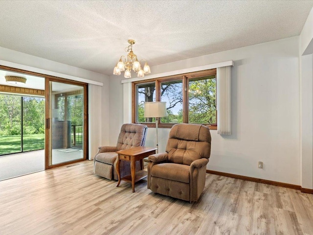 15170 141st Ave, Wadena, MN 56482 - living area featuring light wood-style flooring, a chandelier, healthy amount of natural light, and a textured ceiling