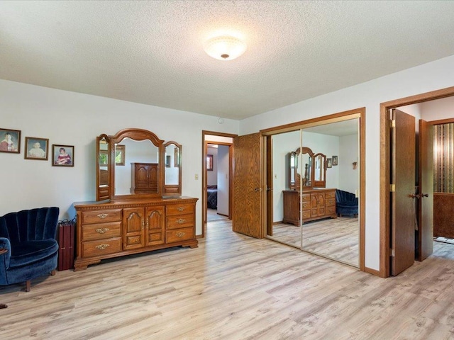 15170 141st Ave, Wadena, MN 56482 - bedroom with light wood-type flooring, a closet, and a textured ceiling