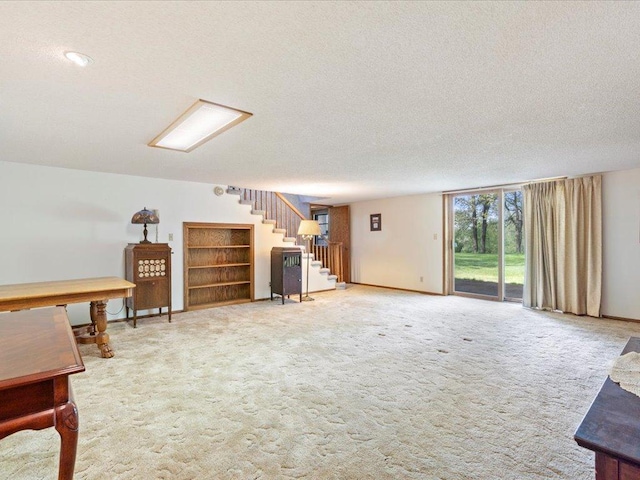 15170 141st Ave, Wadena, MN 56482 - carpeted living room with stairs and a textured ceiling