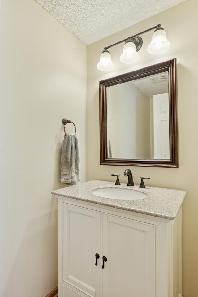 13915 52nd Ave N Unit 1204, Plymouth, MN 55446 - bathroom with a textured ceiling and vanity