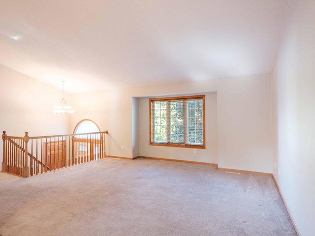 1618 Teton Ct NE, Rochester, MN 55906 - spare room with carpet, a chandelier, and vaulted ceiling