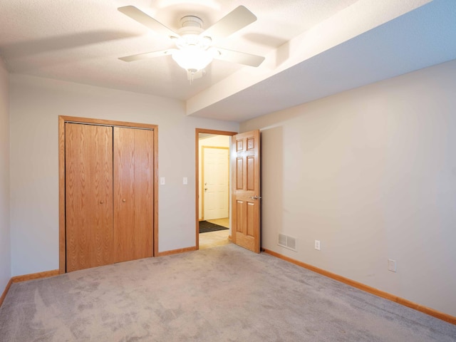 1618 Teton Ct NE, Rochester, MN 55906 - unfurnished bedroom with light carpet, a closet, and a ceiling fan