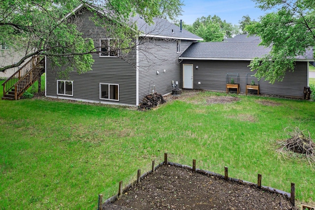 13610 Prairie Ct, Becker, MN 55308 - rear view of property with stairway, a lawn, and roof with shingles