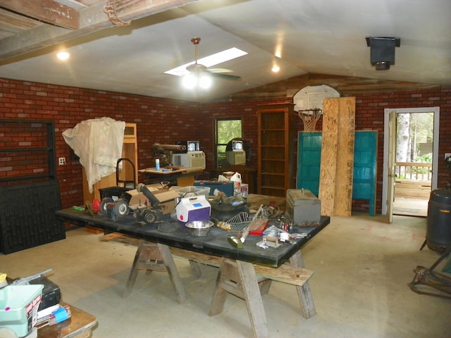 4527 Cushing Ave NW, Buffalo, MN 55313 - miscellaneous room featuring vaulted ceiling, concrete floors, a ceiling fan, and brick wall
