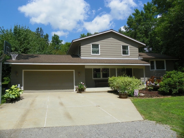 4527 Cushing Ave NW, Buffalo, MN 55313 - view of front of house featuring driveway, a garage, covered porch, and roof with shingles