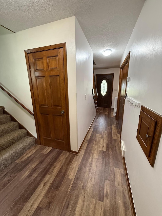 4527 Cushing Ave NW, Buffalo, MN 55313 - hallway with stairway, a textured ceiling, and dark wood finished floors