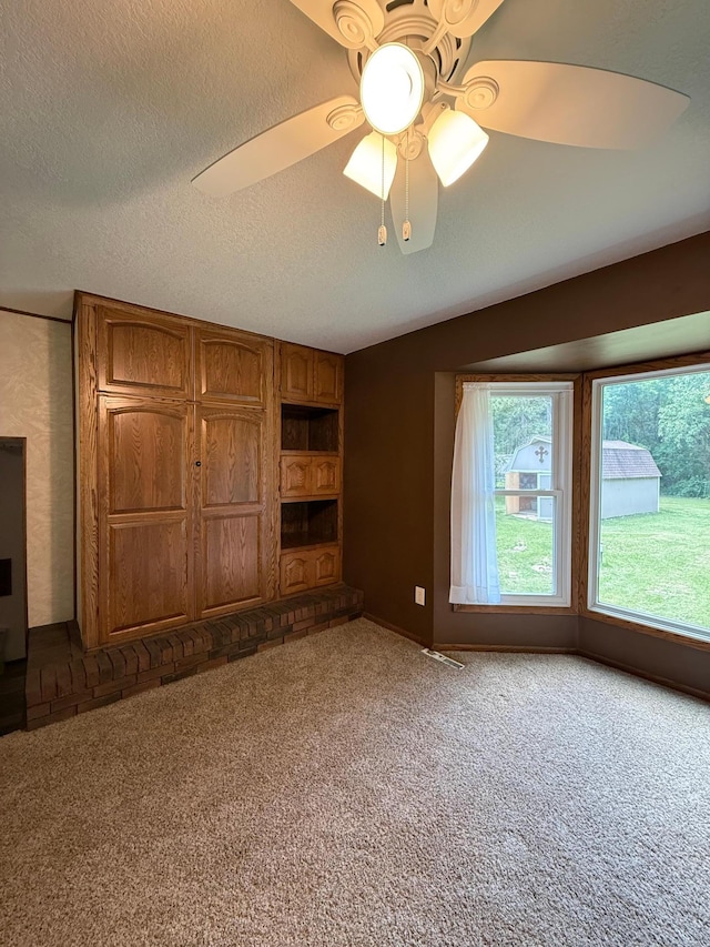 4527 Cushing Ave NW, Buffalo, MN 55313 - unfurnished bedroom featuring carpet flooring, a textured ceiling, and a ceiling fan