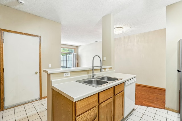 3730 Vermilion Ct S Unit 509, Eagan, MN 55122 - kitchen with white dishwasher, light tile patterned floors, light countertops, a textured ceiling, and a kitchen island with sink