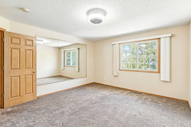 3730 Vermilion Ct S Unit 509, Eagan, MN 55122 - carpeted empty room with baseboards and a textured ceiling